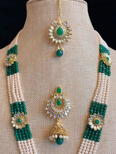 Kundan mala with matching jhumki and Tikka . Glass beads mala 5 layer work. Pendant is about 4 inch wide and long. Green Necklaces With Latkans For Puja, Green Temple Jewelry Sets With Latkans, Green Temple Jewelry Bridal Necklace With Latkans, Green Kundan Bridal Necklace With Latkans, Green Temple Jewelry Mala For Festive Occasions, Green Temple Jewelry Beads For Wedding, Green Round Beads Mala For Wedding, Green Kundan Beads For Gift, Green Kundan Necklace With Round Beads