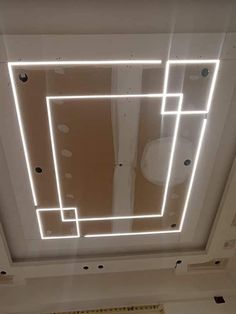 the ceiling is made up of square and rectangle shapes with lights on each side