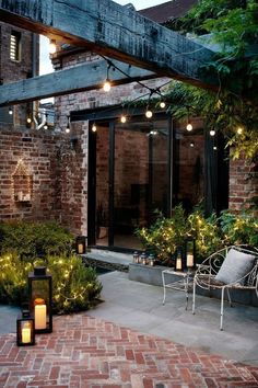 an outdoor patio with brick walls and lights