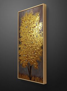 a painting hanging on the wall next to a black wall with a gold leafed tree