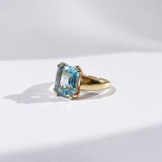 "Find it at a discount and resizing option on our website : https://onisi-paris.com/en/product/gold-and-aquamarine-ring-talhya/ Sublime ring from the 70s in 18-carat gold enhanced with an emerald-cut aquamarine stone. A feminine and elegant ring with a sleek design, just like its central stone, a lagoon blue with fascinating purity. Size: FR 51 / UK L/ US 5.75. Weight: 3.8g Eagle hallmark This unique piece had a previous life in France. The story: belonging to the family of beryls like emeralds, aquamarines get their name from the Latin \"aqua marina\", meaning \"sea water\". It is therefore natural that they have earned the reputation of calming the waves and providing safety to sailors going offshore. Renowned in lithotherapy for facilitating communication, it has also become the stone o Timeless Blue Topaz Ring Perfect As Gift, Timeless Blue Topaz Ring For Gift, Timeless Blue Topaz Ring As Gift, Timeless Blue Topaz Ring, Elegant Light Blue Aquamarine Diamond Ring, Timeless Blue Topaz Gemstone Ring, Yellow Gold Blue Topaz Baguette Cut Ring, Yellow Gold Baguette Cut Blue Topaz Ring, Blue Topaz Baguette Cut Ring In Yellow Gold