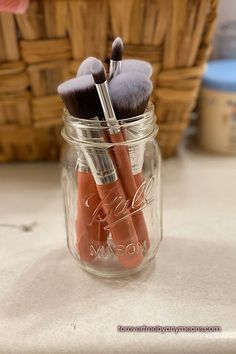 there are three brushes in the jar on the counter