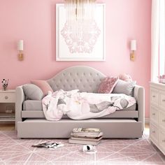 a living room with pink walls and furniture