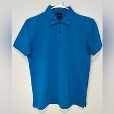 Hugo Boss Short Sleeve Polo Shirt In Xl. Made From High-Quality Piqu Cotton, This Shirt Features A Classic Collar And Button Placket. It’s Brand New But Does Not Have Tags. Ideal For A Stylish, Casual Look. Fitted Blue Button-up Polo Shirt, Classic Blue Button-up Polo Shirt, Classic Blue Polo Shirt With Buttons, Blue Polo Shirt With Collar And Buttons, Fitted Blue Polo Shirt With Placket, Blue Cotton Button-up Polo Shirt, Fitted Blue Polo Shirt, Boss Shirts, Short Sleeve Polo