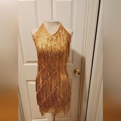 Never Worn Fringe Sequin Mini Dress Gold Sleeveless Flapper Dress For Night Out, Gold Sleeveless Flapper Dress For Party Season, Gold Party Dress With Beaded Fringe, Gold Fringe Mini Dress, Fitted Gold Sleeveless Flapper Dress, Gold Fitted Sleeveless Flapper Dress, Party Mini Dress With Fringe, Knee-length, Elegant Knee-length Fringe Mini Dress, V-neck Fringe Mini Dress For Party