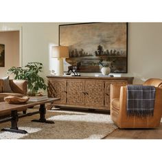 a living room filled with furniture and a painting on the wall above it's fireplace