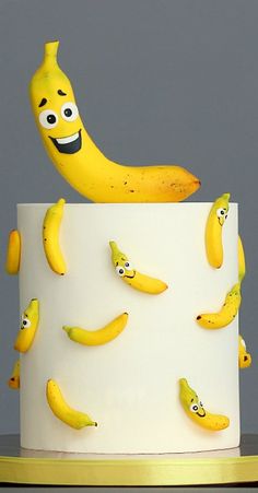 there is a cake with bananas on it and a banana sticking out of the top