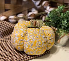 two decorative pumpkins sitting on top of a table