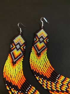 Unique, extra long earrings. Bright yellow orange color. Hypoallergenic clasp Length 6.5 inches (17cm) Width 1 inch (2.5 cm) If you want these earrings in a different color, write to me and I will gladly make them for you. Orange Beaded Jewelry For Festivals, Yellow Beaded Drop Earrings For Festival, Handmade Orange Jewelry For Festivals, Handmade Orange Earrings For Festivals, Orange Teardrop Jewelry For Festivals, Orange Beaded Earrings With Round Beads For Festival, Handmade Long Drop Yellow Jewelry, Orange Drop Earrings For Festival, Handmade Yellow Long Drop Jewelry