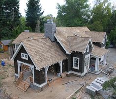 an aerial view of a house being built in the woods with lots of trees around it