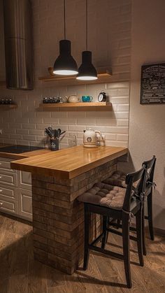 a kitchen counter with two stools next to it