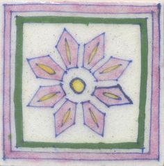 a white and green tile with a flower on the center, surrounded by smaller pink flowers