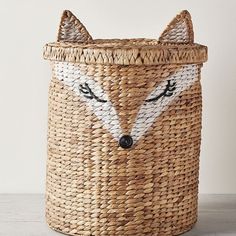 a woven basket with a fox face on it