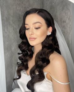 a woman with long hair wearing a wedding dress