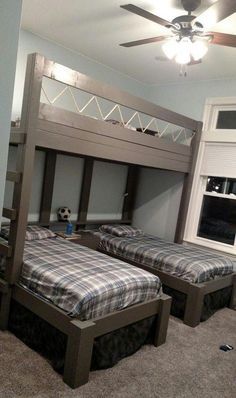 a bedroom with two bunk beds and a ceiling fan