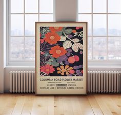 an old poster with flowers on it in front of a window and radiator