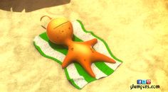 an orange starfish laying on top of a green and white towel