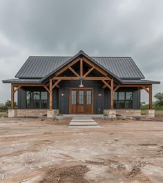 a large house with a metal roof and stone steps leading up to the front door