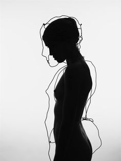 the silhouette of a woman in black and white