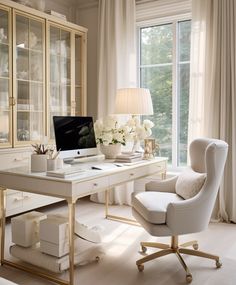 a white desk with a computer on it in front of a window and some curtains