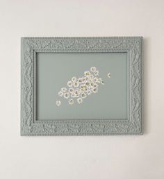 a blue frame with white flowers in it