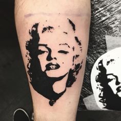 a black and white photo of a marilyn monroe tattoo