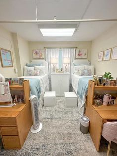 a room with two beds, desks and other items in the room on carpeted flooring