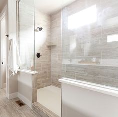 a bathroom with a walk in shower next to a bath tub