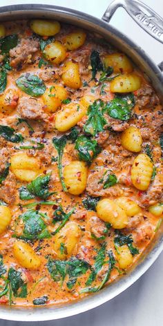 Creamy Sausage Gnocchi with Spinach and Tomato Sauce in a stainless steel pan Pasta With Ground Sausage And Spinach, Gnocchi With Tomato Cream Sauce, Gnocchi Tomato Cream Sauce, Jamie Oliver Recipes 30 Minute Meals, Tuscan Sausage Gnocchi, Creamy Sausage Gnocchi, Tuscan Sausage, Sausage Gnocchi, Pasta Sausage