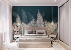 a large bed sitting in a bedroom next to a wall with palm leaves on it