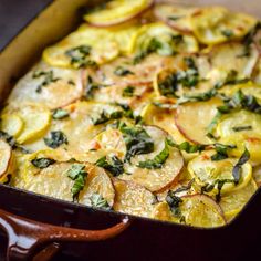 a casserole dish filled with potatoes and spinach