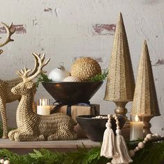 a table topped with christmas decorations and deer figurines on top of a wooden table