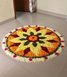 a flower arrangement on the floor in front of a door