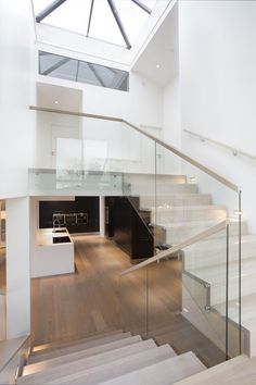 an open floor plan with stairs and glass railings