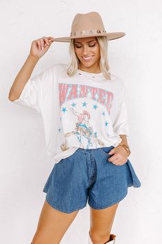 - Saddle up and put on your best boots with this trendy tee! - Unlined lightweight material with subtle distressed detail - A blue, brown, and pink hued 'WANTED' cowboy graphic design - A relaxed silhouette that ends in a straight Measurements S : Bust 42", Hip 44", Length 27.5", Sleeve Length 7.5", Waist 42". M : Bust 46", Hip 48", Length 28.5", Sleeve Length 8", Waist 46". L : Bust 48", Hip 50", Length 29", Sleeve Length 8", Waist 48". Distressed Graphic Tee, Cowboy Graphic, Best Boots, Brown And Pink, Trendy Tee, Cool Boots, Women Clothing Boutique, Distressed Jeans, Online Womens Clothing