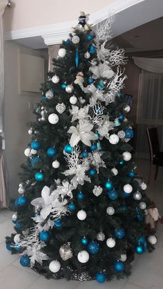 a decorated christmas tree with blue and white ornaments