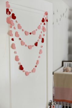 a baby's room decorated with hearts and garlands for valentine's day