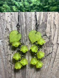 "Pretty, lightweight floral earrings! These have a magical, fae-like feel, perfect for nature lovers!  These earrings feature lime green flowers with semi-translucent lime green beads and lime green leaves. *Length (using default ear hooks): 2.75\"  *Weight (approx, each): 2.5g ✨Upgradable earring options available are: Gauge sizes are approximate. Some options may be in limited supply and may take additional time to ship.  *304 Steel mini hooks, silver color, 22 gauge (0.7mm). This is the perfe Whimsical Green Dangle Jewelry, Spring Green Dangle Earrings, Spring Green Flower Earrings With Ear Wire, Green Dangle Earrings For Spring, Spring Green Flower Earrings, Green Earrings For Spring, Whimsical Green Dangle Earrings, Green Spring Jewelry With Ear Wire, Green Dangle Jewelry For Spring