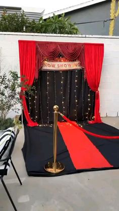 a stage set up with red and black drapes