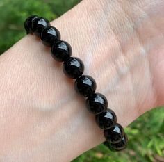 "Black Onyx Bracelet - natural, genuine, round crystal beads Weight: 17-18g Bracelet Size: 6.50\"-6.75\" Bead Size: ~8.25mm This listing is for one Black Onyx crystal bracelet. Stones are round beads. Your bracelet will be chosen for you randomly. Photos show the examples. Bracelets are stretchable. They could be used for crystal healing, meditation, or as a jewelry. These bracelets are not returnable. Onyx is good for decision-making. It brings luck and happiness in the home. It helps with grie Bracelet Stones, Crystal Meditation, Onyx Crystal, Black Onyx Bracelet, Crystals Healing, Types Of Crystals, Ball Bracelet, Onyx Bracelet, Healing Meditation