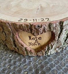 a tree stump with a heart carved into it's center and date on the log