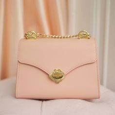 Our 'Venus' handbag is a creation inspired by the beauty and serenity of femininity. Featuring our signature 'Old World' charm, yet designed with the modern woman on the go in mind. Handcrafted from the finest Saffiano leather, the design of the gold hardware is inspired by the legend of the 'Birth of Venus', featuring a seashell motif, with a graceful bow, and a small pearl adorning the clasp. The sophisticated chain strap can be worn crossbody, or doubled-up and carried under your arm.    Resp Luxury Gold Flap Bag, Elegant Gold Flap Bag, Luxury Flap Bag With Detachable Strap For Everyday, Elegant Everyday Luxury Flap Shoulder Bag, Luxury Clutch Flap Bag As Gift, Luxury Clutch Flap Bag For Gift, Luxury Crossbody Flap Bag As Gift, Luxury Gift Flap Clutch Bag, Luxury Shoulder Bag With Detachable Strap As Gift