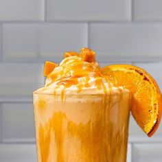 an orange smoothie is garnished with caramel and drizzle