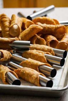 there are many croissants on the tray ready to be cooked in the oven