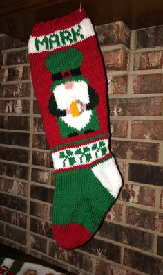 a christmas stocking hanging on a brick wall