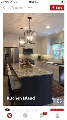 a large kitchen with an island in the middle and lots of lights hanging from the ceiling