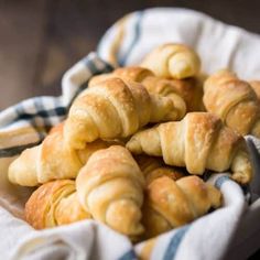 several croissants in a basket on a table