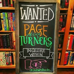 a chalkboard sign that reads wanted page turners insure within is in front of bookshelves