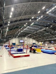 an indoor trampoline facility with people on the ground