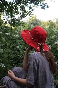 "The 'Arwen' hat is a beautiful linen sun hat perfect for long summer days in the garden and exploring nature. Made from high quality 100% natural linen in a True red colour.  The hat has French millinery wire within the brim edge to give it a perfect romantic, artisanal look, the whole look of this hat is intended to give a perfectly imperfect feel of a casual easy to wear summer hat that has a very pretty silhouette. The brim of the Arwen is also slightly A-Symmetrical thanks to the split in t Bohemian Adjustable Sun Hat For Garden Party, Adjustable Bohemian Sun Hat For Garden Party, Red Summer Sun Hat For Spring, Red Sun Hat For Spring And Summer, Red Bucket Hat For Summer Outdoor, Bohemian Sun Hat With Curved Brim For Picnic, Red Sun Hat For Spring Vacation, Bohemian Straw Hat For Garden Party, Bohemian Brimmed Sun Hat For Picnic